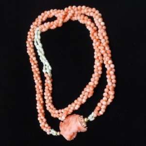   of coral medallion. No clasp; its long enough to fit over the head