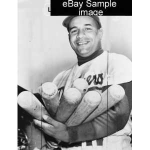   Roy Campanella in baseball uniform, holding six bats