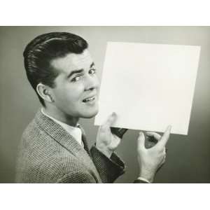  Man Holding Blank Sheet of Paper in Studio, Portrait 